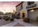 Beautiful two-story home featuring stone accents, a well-manicured front yard, and inviting walkway at 470 N 168Th Ln, Goodyear, AZ 85338