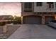 Spacious two-car garage with a private driveway and well-kept landscaping near a cluster of units at 470 N 168Th Ln, Goodyear, AZ 85338