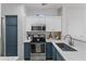 Modern kitchen featuring stainless steel appliances, white cabinets, and an island with a marble countertop at 470 N 168Th Ln, Goodyear, AZ 85338