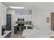 Modern kitchen featuring stainless steel appliances, white cabinets, and an island with a marble countertop at 470 N 168Th Ln, Goodyear, AZ 85338
