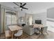 Bright living room with a ceiling fan, modern furniture, and plenty of natural light at 470 N 168Th Ln, Goodyear, AZ 85338