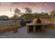 Impressive outdoor kitchen featuring a pizza oven, grill, and stone counterspace perfect for outdoor entertaining at 470 N 168Th Ln, Goodyear, AZ 85338