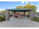 Covered picnic area with stone pillars and multiple tables, perfect for enjoying outdoor meals and gatherings at 470 N 168Th Ln, Goodyear, AZ 85338