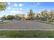 Well-maintained sand volleyball court in a community park with lush green surroundings and clear skies at 470 N 168Th Ln, Goodyear, AZ 85338