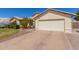 Home with a large driveway, desert landscaping, and a two-car garage at 4804 W Commonwealth Pl, Chandler, AZ 85226