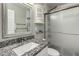Bathroom featuring granite countertops, a framed mirror, and glass shower doors at 520 N Stapley Dr # 286, Mesa, AZ 85203