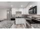 Updated kitchen with granite countertops, stainless appliances, and white cabinetry at 520 N Stapley Dr # 286, Mesa, AZ 85203