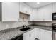 Updated kitchen with granite countertops, stainless appliances, and white cabinetry at 520 N Stapley Dr # 286, Mesa, AZ 85203