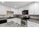 Updated kitchen with granite countertops, stainless appliances, and white cabinetry at 520 N Stapley Dr # 286, Mesa, AZ 85203