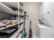 Laundry room with stacked washer and dryer, storage shelves with cleaning supplies at 520 N Stapley Dr # 286, Mesa, AZ 85203