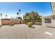 Desert landscaping, privacy walls, and mature trees in the backyard at 5865 E Anaheim St, Mesa, AZ 85205