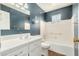 Bathroom with a tub, tile surround, sink, and large mirror at 5865 E Anaheim St, Mesa, AZ 85205