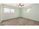 Bright bedroom featuring neutral paint, carpet, and natural light from windows at 5865 E Anaheim St, Mesa, AZ 85205