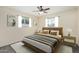 Comfortable bedroom featuring large bed, side tables, carpet, and natural light at 5865 E Anaheim St, Mesa, AZ 85205