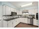 Bright kitchen with white cabinets, granite countertops, and stainless steel appliances at 5865 E Anaheim St, Mesa, AZ 85205