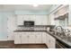 Bright kitchen with white cabinets, granite countertops, and stainless steel appliances at 5865 E Anaheim St, Mesa, AZ 85205