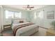 Bright, spacious main bedroom with large windows, ceiling fan, and neutral color palette at 5865 E Anaheim St, Mesa, AZ 85205