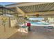 Community pool area with covered seating, rules board, and desert landscaping at 5865 E Anaheim St, Mesa, AZ 85205