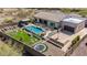 Stunning aerial view of the backyard with pool, spa, outdoor kitchen, and recreation area at 6328 W Fetlock Trl, Phoenix, AZ 85083