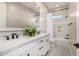 Bright bathroom with dual sinks, quartz countertop, and shower-tub combination at 6328 W Fetlock Trl, Phoenix, AZ 85083