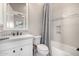 Bright bathroom featuring a granite sink, white cabinets, and tile accents above the tub at 6328 W Fetlock Trl, Phoenix, AZ 85083