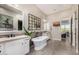 The bathroom features dual sinks, a soaking tub, and modern fixtures at 6328 W Fetlock Trl, Phoenix, AZ 85083