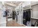Spacious walk-in closet with custom shelving, cabinets, and ample hanging space at 6328 W Fetlock Trl, Phoenix, AZ 85083