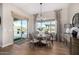 The dining area showcases a round table and provides access to a luxurious outdoor pool at 6328 W Fetlock Trl, Phoenix, AZ 85083