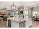 Gourmet kitchen features an island with a sink, stainless steel appliances, and a wine cooler at 6328 W Fetlock Trl, Phoenix, AZ 85083