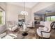 Open-concept living room featuring hardwood floors, neutral tones, modern lighting, and comfortable seating at 6328 W Fetlock Trl, Phoenix, AZ 85083