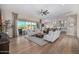 Bright living room with hardwood floors, a ceiling fan, and an open concept design at 6328 W Fetlock Trl, Phoenix, AZ 85083