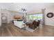Bright living room with hardwood floors, a ceiling fan, and lots of windows at 6328 W Fetlock Trl, Phoenix, AZ 85083