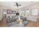Comfortable living room with sectional sofa, area rug, and natural light at 6328 W Fetlock Trl, Phoenix, AZ 85083