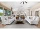 Inviting living room with hardwood floors, a ceiling fan, and plenty of seating at 6328 W Fetlock Trl, Phoenix, AZ 85083