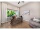 Bright home office featuring hardwood floors, a large window, and stylish desk at 6328 W Fetlock Trl, Phoenix, AZ 85083