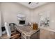 Well-lit office space with a decorative wooden desk and comfortable seating area at 6328 W Fetlock Trl, Phoenix, AZ 85083