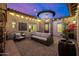 Cozy patio space with comfortable seating, string lights, and unique architectural features at 6328 W Fetlock Trl, Phoenix, AZ 85083