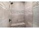 Modern walk-in shower with tiled walls, bench, and rainfall shower head at 6328 W Fetlock Trl, Phoenix, AZ 85083