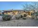 Home backyard featuring gravel landscaping, a covered patio, and views of the surrounding desert landscape at 6545 E Ponderosa Loop, Gold Canyon, AZ 85118