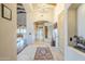 Welcoming foyer with tile floors, arched doorways, a decorative rug, and views of the kitchen at 6545 E Ponderosa Loop, Gold Canyon, AZ 85118