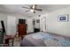 A beautiful bedroom features a ceiling fan, dresser, and a window for natural light at 711 E Laurel Dr # 17, Casa Grande, AZ 85122