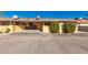 Charming home featuring a covered carport and well-maintained landscaping with decorative shrubs and colorful flower accents at 711 E Laurel Dr # 17, Casa Grande, AZ 85122