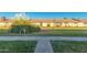 Exterior view of the townhome complex has sidewalk and verdant lawns at 711 E Laurel Dr # 17, Casa Grande, AZ 85122