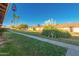 A long sidewalk bisects the green lawn leading to neat townhomes in an outdoor setting at 711 E Laurel Dr # 17, Casa Grande, AZ 85122