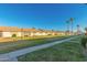 Townhome community boasting lush green lawn, mature palm trees, and tidy landscaping at 711 E Laurel Dr # 17, Casa Grande, AZ 85122