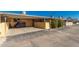 Inviting home exterior featuring a carport with a covered motorcycle and manicured shrubs, offering curb appeal at 711 E Laurel Dr # 17, Casa Grande, AZ 85122