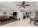 Open-concept living space with tiled floors, a kitchen view, and a ceiling fan for added comfort at 711 E Laurel Dr # 17, Casa Grande, AZ 85122