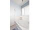 Bathroom featuring a soaking tub and a bright white door at 7712 S 37Th Way, Phoenix, AZ 85042