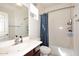 Bright bathroom with a shower/tub combo, large mirror, and dark wood vanity at 7712 S 37Th Way, Phoenix, AZ 85042