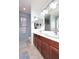 Bright bathroom features double sinks, wood cabinets, and a large mirror at 7712 S 37Th Way, Phoenix, AZ 85042